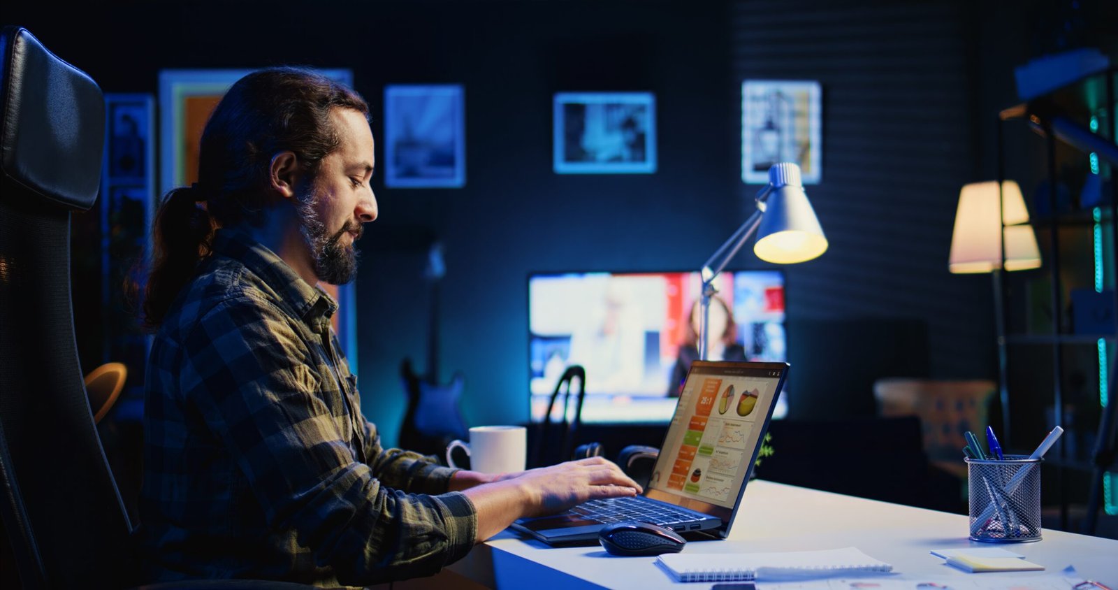 Man working in personal office, checking statistical data financial graphs